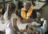 Palmer Lions Club member Bert Verrall talks with Abby Kenley, a Winners Circle 4-H Club volunteer, Saturday during the 46th annual Palmer Lions Club Gun Show at Raven Hall in Palmer. The 4-H 