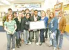 ROBERT DeBERRY/Frontiersman Colony High School students present
a $2,104.20 check to Eva Stanfield, center in blue, Thursday
afternoon at Palmer Junior/Middle School. The Stanfield’s home was
