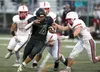 A trio of Wasilla Warriors work to bring down Colony's Julian Ates during Colony's 17-7 win over Wasilla. Bruce Eggleston/matsusports.net