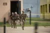 Members of the 4th Infantry Division run from one building to another at Selby Combined Arms Collective Training Facility on Fort Benning, Ga., during the 36th Best Ranger Competition in Apri