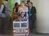 Eric Edwards, 6, smiles as mom Judy Edwards works the lights and sirens with her iPhone on Eric’s new custom fire truck wheelchair. Firefighters with the 673rd Civil Engineer Squadron at Join