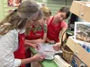 Wendy, Jennifer and Heidi Anzilotti flip through an old ledger looking for specific details of the beginning of Anzilotti's Tuscan Market, located across from Essential One on the Palmer-Wasi