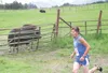 MATT TUNSETH/Frontiersman Jake Parisien runs past a musk ox
during the fifth annual Running With the Bulls at the Musk Ox Farm
outside of Palmer on Sunday. Parisien, a 17-year-old senior at
P