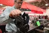 Doug Albright of Doug's Repairs in Fairbanks explains how an old scope on a World War II-era Browning .50-caliber machine gun once used in Hollywood movies at the Wasilla High hockey booster'