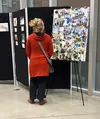 A visitor takes in the student artwork from Palmer High School and Onward &amp; Upward’s Outdoor Recreation class, displayed in the Glenn Massay Theatre lobby. Russell Clark/For the Frontiers