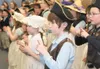 Costumed second- and third-graders Zachery France, Rhiannon O’Shea, Abby Hall, Sam Snively, Karley Forster and Hannah Beer sing and sign ‘God Bless America’ during a patriotic celebration Thu
