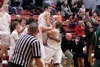 A group of Wasilla Warriors celebrate and lift senior Beau Cork after Cork drained a three-pointer at the buzzer in Wasilla's 70-33 win over Service Friday at Wasilla High School. The basket 
