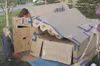 Elias Morock, 8, peeks out of his family’s winning cardboard
‘townhouse,’ where he and his older brothers Ayden, 10, and Isaiah,
13, shared cramped quarters with their parents, Daulton and Ma