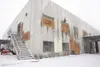 ROBERT DeBERRY/Frontiersman The broken windows at Wasilla Bible
Church have been covered with sheets of plywood as workers inside
the building begin the clean-up process following a suspiciou