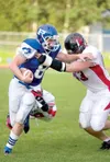 ROBERT DeBERRY/Frontiersman Palmer Moose Jackson Buresh tries to
push past a pair of Juneau-Douglas defenders during Friday’s game
at Palmer high School. The Crimson Bears escaped Machetanz F
