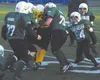 The Colony defense swarms a Panther runner to cause a fumble
during the fifth/sixth-grade championship game at Anchorage
Football Stadium. Photo by TIM BRODT/Frontiersman.