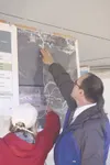 Palmer KeyBank Branch Manager John Nelson asks Mat-Su CVB Exec.
Director Bonnie Quill about the various options for locating a new
Visitor Center in the Valley during a “Gateway Gathering” ev