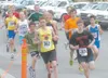 Participants in Sunday’s Bill Mitchell 5-kilometer race make a
turn at the start of the race in downtown Palmer. More than 100
men, women and children took part in this year’s race. Palmer’s
