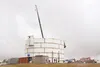 Construction work on the hilltop water tower overlooking Trunk Road continued Friday. The tower, which will eventually be painted to resemble a stand of birch trees, is necessary to increase 