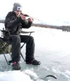 Houston High School freshman Colt Conner lands a landlock salmon on Finger Lake during the championship day competition of the Mat-Su high school ice fishing championships. He and partner Jam