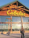 Jehnifer and Butch Ehmann stand in front of Alaska’s first Cabela’s store, which opens Thursday morning in South Anchorage. The Ehmanns have landed a unique opportunity with the outdoors outf