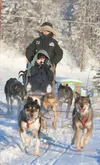 Aimee King holds up her camera as she takes a sled dog ride at the Mat-Su Borough Animal Control Facility in this Frontiersman 2012 file photo. The facility is offering dog sled rides Saturda
