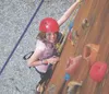Girl Scout Alyssa Griste climbs on the climbing wall at Camp Togowoods near Three Mile Lake. The Girl Scouts of Alaska recently received a grant to purchase new safety equipment at the facili