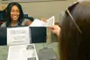JACKSONVILLE, Fla. (Oct. 3, 2019) – Lajoy Telfair, a medical clerk at Naval Hospital Jacksonville’s Internal Medicine Clinic, hands check-in information to a patient. Telfair, a native of Cle