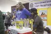 49th State Brewing Company co-owner Russ Hathaway, left, and employee Logan Olsen chat while pouring beer for Mighty Matanuska Brewfest patrons in Raven Hall at the Alaska State Fairgrounds. 
