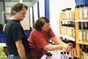 John Egan and Judy Randels of Alaska Midnite Sun Scents arrange their booth for the Mat-Su Home Builders’ 35th Annual Home Show April 10 to 12 at the Curtis D. Menard Memorial Sports Center. 