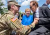 Former Sen. Bob Dole shakes hands with Lt. Col. Michael Lind with the Army’s G-1 office during Dole’s honorary promotion ceremony at the World War II Memorial in Washington, D.C., May 16, 201