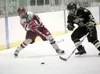 ROBERT DeBERRY/Frontiersman Wasilla forward Zach Korsmo sends a
shot on goal before being checked by South Anchorage defenseman
Raymond Schulte during a 2-1 loss to the Wolverines at the Curt