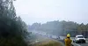 A single lane of traffic drives through the smoke from the McKinley Fire Wednesday. Tim Rockey/Frontiersman