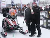 2015 Iron Dog champions Eric Quam, right, and Scott Faeo, left, celebrate their finish with a bottle of champagne, near the finish of the 2,000-mile snowmachine race across Alaska on the Chen