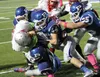 A group of Palmer players work to bring down Wasilla's Mosiah Renk during a Wasilla win over Palmer in the Potato Bowl Oct. 3. Palmer and Wasilla are both in the postseason. The Moose face So