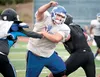 Palmer lineman Brian Thompson pushes past a pair of Chugiak Mustangs during the Chugiak Stampede at Tom Huffer Sr. Staduim at Chugiak High School. Palmer opens its 2013 season tonight against