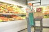 CHRIS GILLOW/Frontiersman Produce clerk Will Dodd stocks bins in
the produce section at the new Three Bears store in Meadow Lakes.
The new location has a full line of fruits and vegetables.