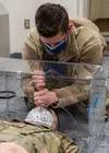U.S. Air Force Senior Airman Michael Shoemaker, 673d Medical Support Squadron biomedical equipment technician, demonstrates how intubation might look on U.S. Air Force Staff Sgt. Andrew Taylo
