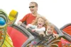 ROBERT DeBERRY/FrontiersmanAlways a crowd pleaser at the Alaska
State Fair, the Orient Express provides a thrill ride for Jason
Copp, left, his daughter Zoe, 5, and son Ethan. The fair opened