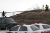 Alaska State Troopers gather evidence at a pullout near Mile 52, Glenn Highway Thursday. Troopers are investigating the shooting death of Frank L. Pushruk, 45, of Palmer, whose death was firs