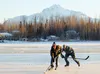 Bob Piff, left, tries to keep the puck away from Jed Tapani on Sunday, Nov. 15 on Finger Lake. The Palmer men were among four who cleared the ice on Finger Lake on Sunday for a short game of 
