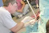 Photos by MATT TUNSETH/Frontiersman Dr. John Tuomi performs an
operation to remove a damaged eyeball from a caribou last week at
the Palmer Veterinary Clinic. The operation was carried out on