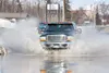 A pickup truck blasts through a puddle on Mayflower Court near the Mat-Su Valley Frontiersman newspaper office Monday afternoon. Robert DeBerry
