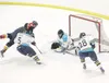ROBERT DeBERRY/Frontiersman Alaska Avalanche forward Larry
Kincaid, No. 5, takes down Fairbanks’ Alex McRae as goaltender Adam
Kraus blocks McRae’s shot during Alaska’s 4-3 shootout win over 