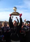 Houston defensive coordiator hoists the trophy after the Hawks beat Barrow 41-8 in the Division III state championship game. Courtesy of Bruce Eggleston/matsusports.net