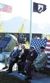 Top, the American and POW/MIA flags frame Pioneer Peak during
the Alaska POW/MIA Day ceremony Friday. Above, from left, Walt
Fergus, Bill Plate, Paul Wilson and Larry Laurence listen to
Charl