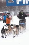 Robert Redington of Knik heads out on the trail at the start of the Northern Lights 300 Jan. 23 at Martin Buser’s Happy Trails Kennel in Big Lake. Weather stopped mushers for two hours at the