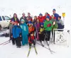 Members of the Mat-Su Junior Nordics ski club pose for a photo with U.S. Olympic skiers Kikkan Randall and Holly Brooks at Independence Mine in Hatcher Pass, November 2013. Courtesy Dave Musg