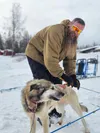 A local veteran connects a sled dog to a gangline during a recent training session of Operation Arctic Renewal, a new outdoor rehabilitation program for veterans healing from battle wounds. “