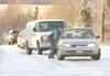 ROBERT DeBERRY/Frontiersman Alaska State Trooper Jim Lindberg
pushes a car up the hill at the intersection of the Seward Meridian
Parkway and Bogard Road Monday morning. Several motorists bec