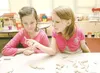 ROBERT DeBERRY/Frontiersman Jessica Cuculla, 8, left, and Torrey
Zook inspect a dinosaur bone during a hands-on workshop Monday
afternoon at Shaw Elementary School. The girls learned about al
