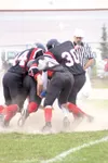MATT TUNSETH/Frontiersman Houston players pile on a Barrow ball
carrier during the fourth quarter of the Hawks’ 48-13 win over the
Whalers Saturday at Houston High School. The Hawks improved 