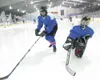 ROBERT DeBERRY/Frontiersman Goalie Carrie Curran forces Missy
Keil, left, past the goal during a learn to play hockey class at
the Palmer Ice Arena.
