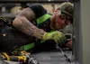 Jessie Mauldin, 673d Logistics Readiness Squadron heavy mobile equipment mechanic, attaches an eyelet on top of a deicing truck to tether a fall-protection safety harness at Joint Base Elmend