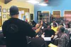 Mat-Su Borough Emergency Manager Casey Cook (facing away) leads a discussion with residents along the Matanuska River about a federal program that could buy them out of their fast-eroding pro